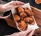 Woman hands holding grilled meat or shish kebab, shashlik on pita bread on wooden board. Top view