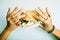 Woman hands holding hamburger with money, jewelry, cosmetic, soc