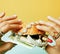 Woman hands holding hamburger with money, jewelry, cosmetic, social issue wealth concept close up