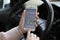 Woman hands holding iPhone 6S with application Taxi Uber