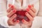 Woman hands holding large glass of wine.