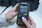 Woman hands holding personal military search dosimeter-radiometer for measuring levels of radiation