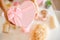 Woman hands holding pink colored heart shaped gift boxes of bath and body products for bridesmaids.