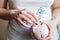 Woman hands holding pink piggy bank and putting money Euro