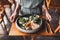 Woman hands holding plate with oriental breakfast