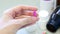 Woman hands holding a purple capsule of Clindamycin, used to treat bacterial infections, or treat patients who have an allergic.