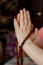 Woman hands holding rudraksha rosary with the namaste mudra