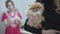 Woman hands holding small dog pomeranian spitz waiting for medical examination in veterinary clinic close up. Blured