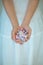 Woman hands holding some vintage candy, sensual rural studio shot