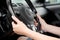 Woman hands holding steering wheel