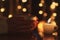 Woman hands holding tea cup on the table with burning candle. Special soft focus effect