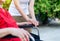 Woman hands holding to asian mature sitting on wheelchair,Senior insurance concept