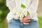 Woman hands holding white lilac blooms in her hands