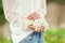 Woman hands holding white lilac blooms in her hands