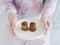 Woman hands holding white round plate of Assorted Canneles