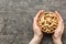 Woman hands holding a wooden bowl with close peanuts. Healthy food and snack. Vegetarian snacks of different nuts