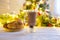 Woman hands ith cup of hot chocolate on christnas tree background