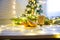 Woman hands ith cup of hot chocolate on christnas tree background