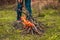 Woman hands kindle a big bonfire in the forest. Person making fire