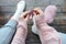 Woman hands knitting small newborn sock