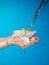 Woman hands with lily and stream of water.