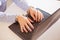 Woman hands locked to laptop by chain on keyboard of notebook