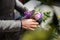 Woman hands making a pretty lilac bouquet of flowers