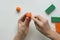 Woman hands making strips with tooth stick on orange ball from polymer clay for create orange fruit