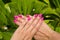 Woman hands with manicured pink nails closeup. Skin and nail car