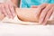 Woman hands mixing dough on the table