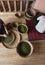 Woman hands over green raw pepper and separates black pepper from red for further drying. Black pepper plants growing on