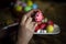 Woman hands is painting eggs with floral patterns acrylic. Decorating egg. Preparation for Easter. Selective focus. Close-up