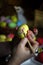 Woman hands painting eggs with floral patterns. Preparing for Easter. Artist paints an Easter egg. Close-up. Selective focus