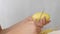A woman hands peeling organic yellow potatoes with knife close up view.