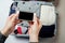 Woman hands with phone on the background of Open suitcase packed