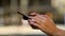 Woman, hands and phone typing in city for communication, social media or outdoor networking in road or street. Closeup