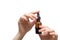 Woman hands with pink manicure. Female holding essential oil bottle. Female healthcare wellness concept