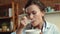 Woman hands pouring milk into cornflakes bowl. Woman eating cereal at home.