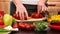 Woman hands preparing cherry tomatos for a vegetables salad