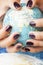 Woman hands with purple manicure holding Earth ball, global planet issues concept
