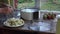 Woman hands put cut pear pieces in fruit dryer machine dish. Closeup. 4K