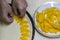 Woman hands putting pieces of apricot on the raw dough close up