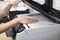 Woman hands putting a sheet of paper into a copying device