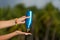 Woman hands putting sunscreen from a suncream bottle