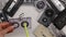 Woman hands reel the tape back in audio cassette using a pen - top view, closeup