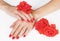 Woman hands with scarlet manicure and roses