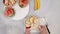 Woman hands serving fruit salad, close up video, flat lay.