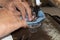 Woman hands sewn fabric repairs on sewing machine