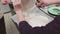 Woman hands spills creamy dough on baking tray covered in cooking paper
