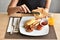 Woman hands spreading butter on the bread